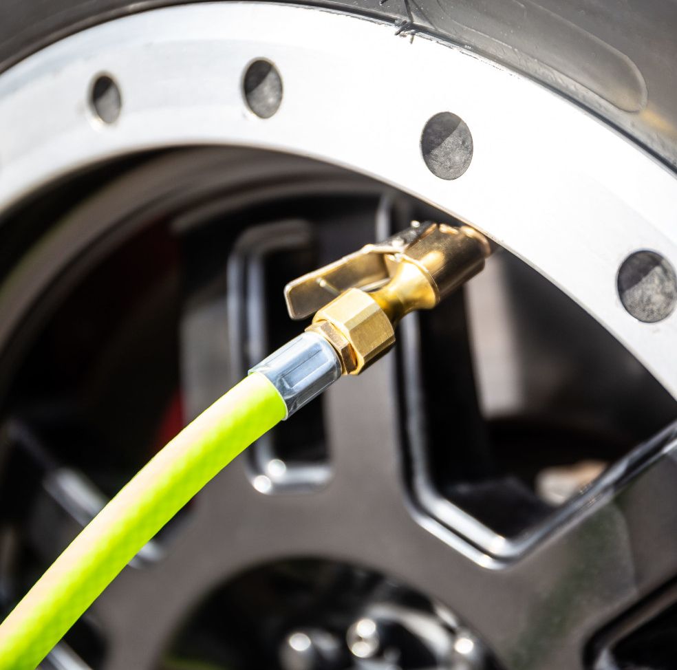The brass clip connector locked onto a tyre valve.